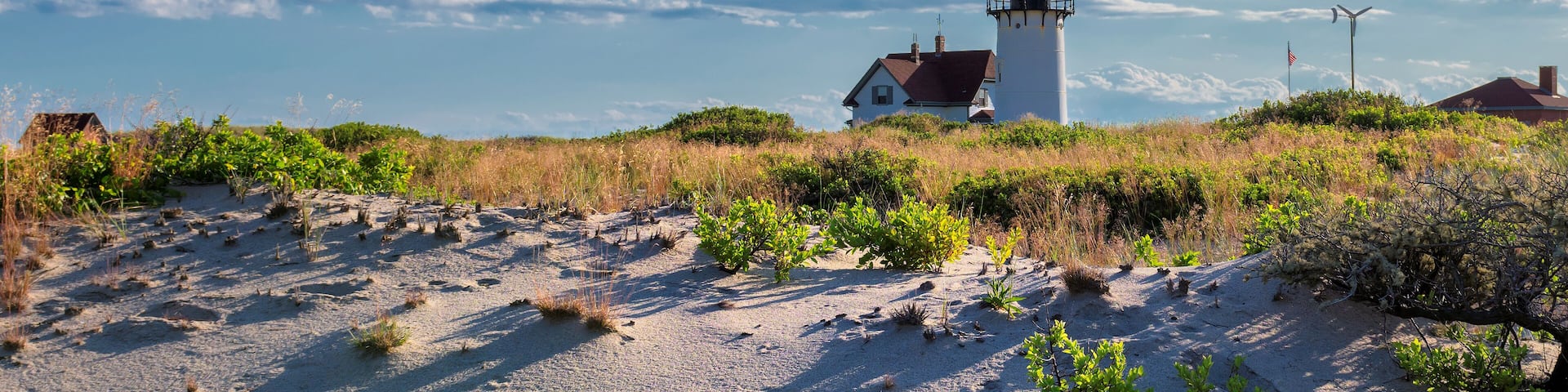 Lighthouse Point on beach dunes, Race Point Light Lighthouse in Cape Code, New England, Massachusetts, USA.