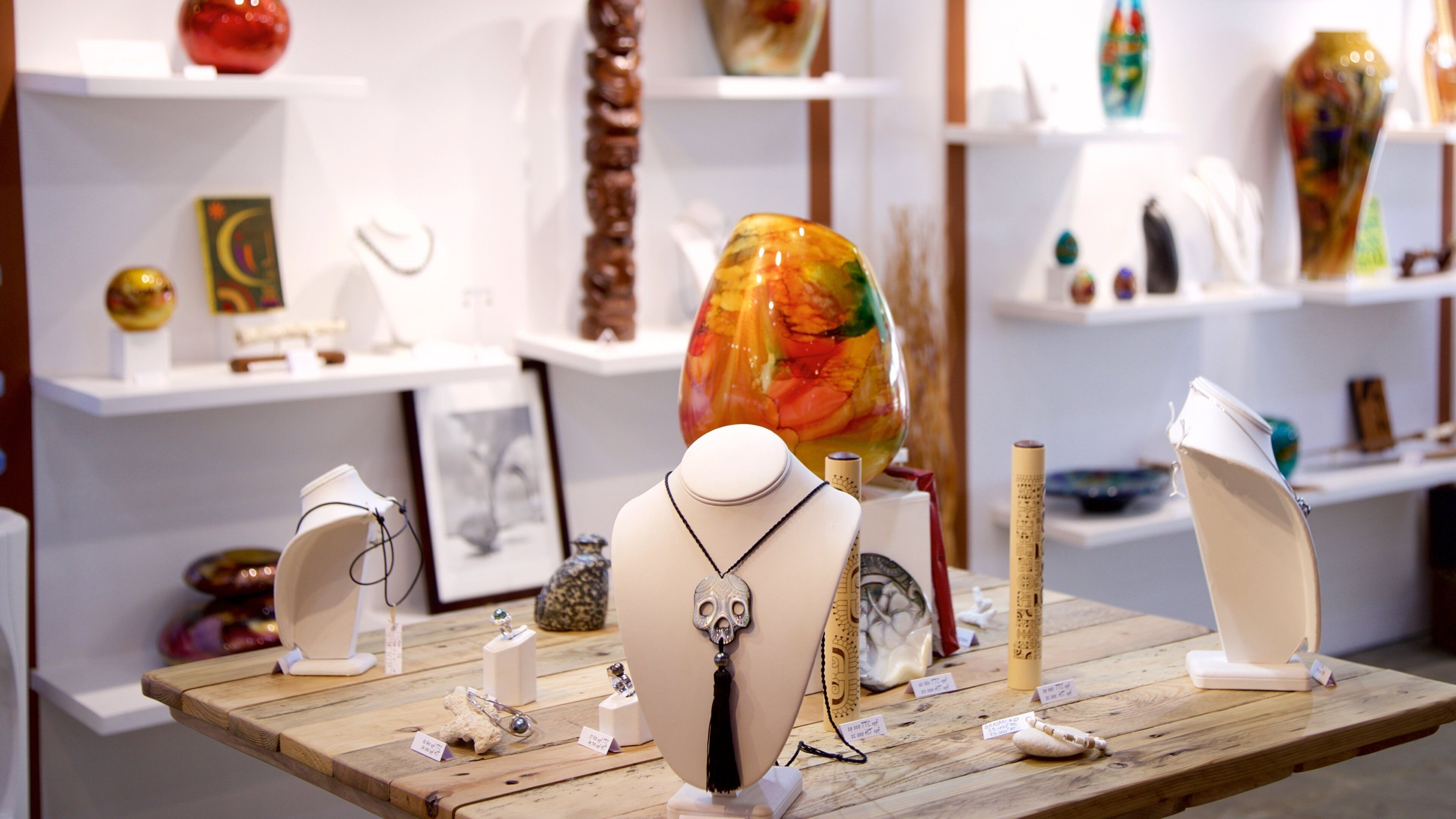 A jewelry display with various items on wooden stands.