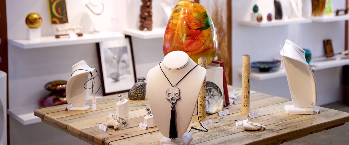 A jewelry display with various items on wooden stands.
