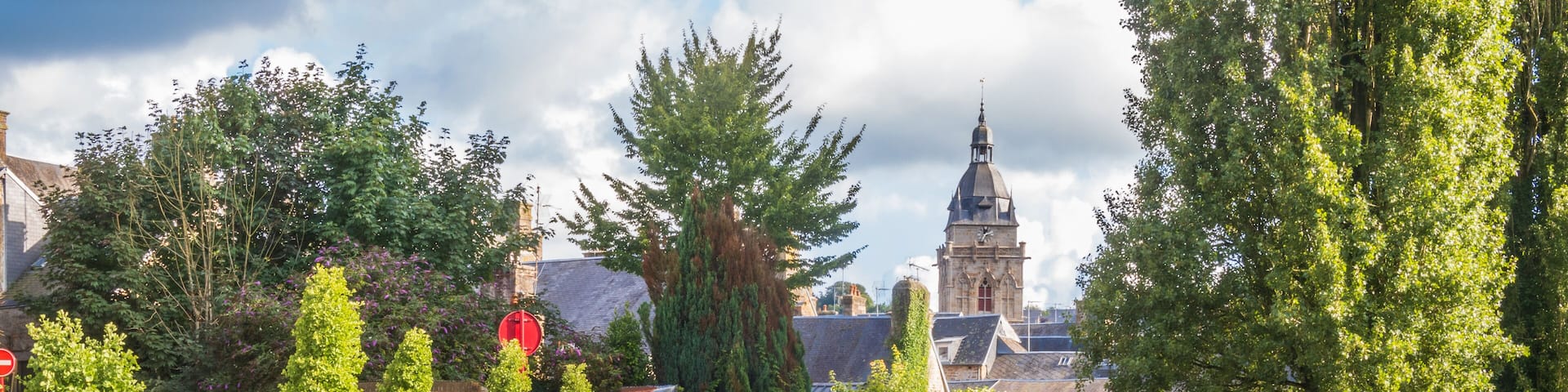 The wash houses of the quays and the bell tower of the church in Villedieu-les-Poêles in Normandy