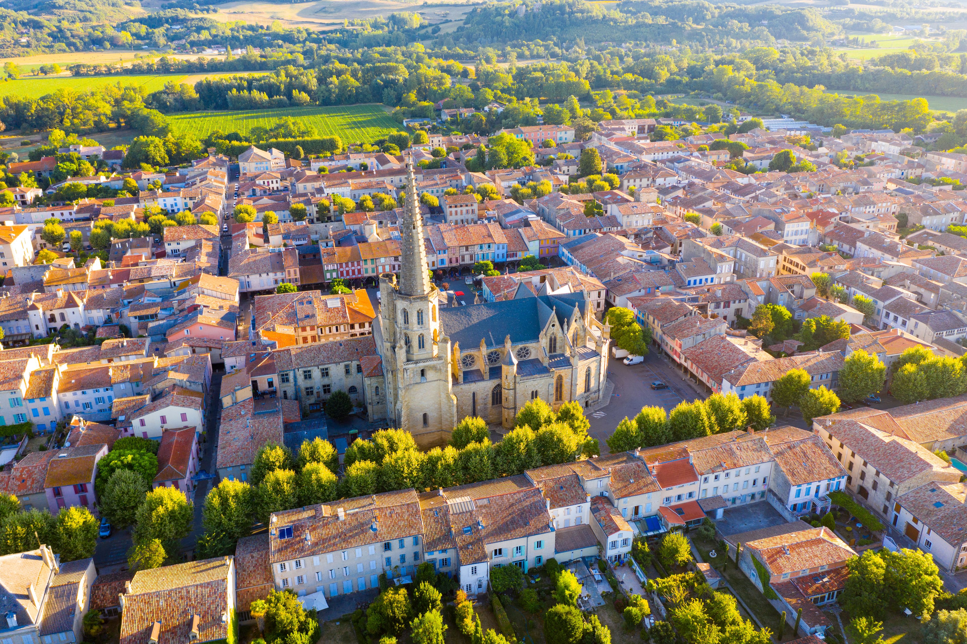 Scenic aerial view of Mirepoix town and surroundings in Hers valley in summer overlooking Gothic building of Roman Catholic Cathedral, France..