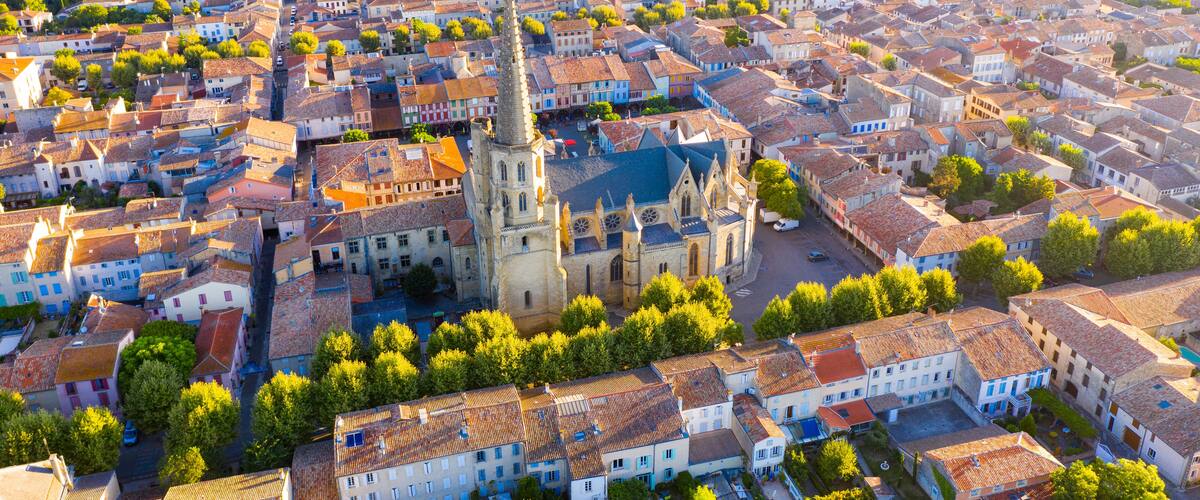 Scenic aerial view of Mirepoix town and surroundings in Hers valley in summer overlooking Gothic building of Roman Catholic Cathedral, France..