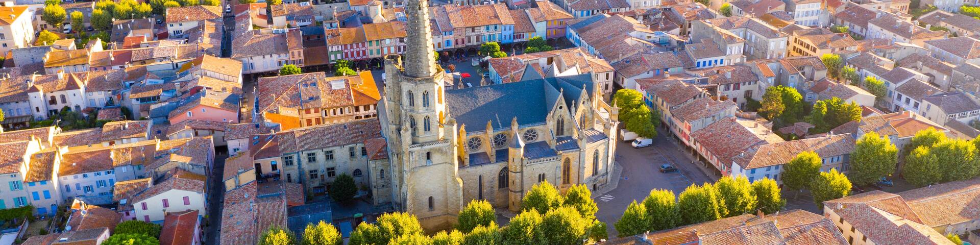 Scenic aerial view of Mirepoix town and surroundings in Hers valley in summer overlooking Gothic building of Roman Catholic Cathedral, France..