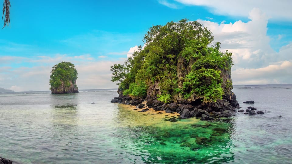 The iconic offshore rock formations known as Fatumafuti (also Fatu ma Futi or Tower Rocks) in American Samoa. Associated with a Samoan love story legend. Tutuila Island, American Samoa