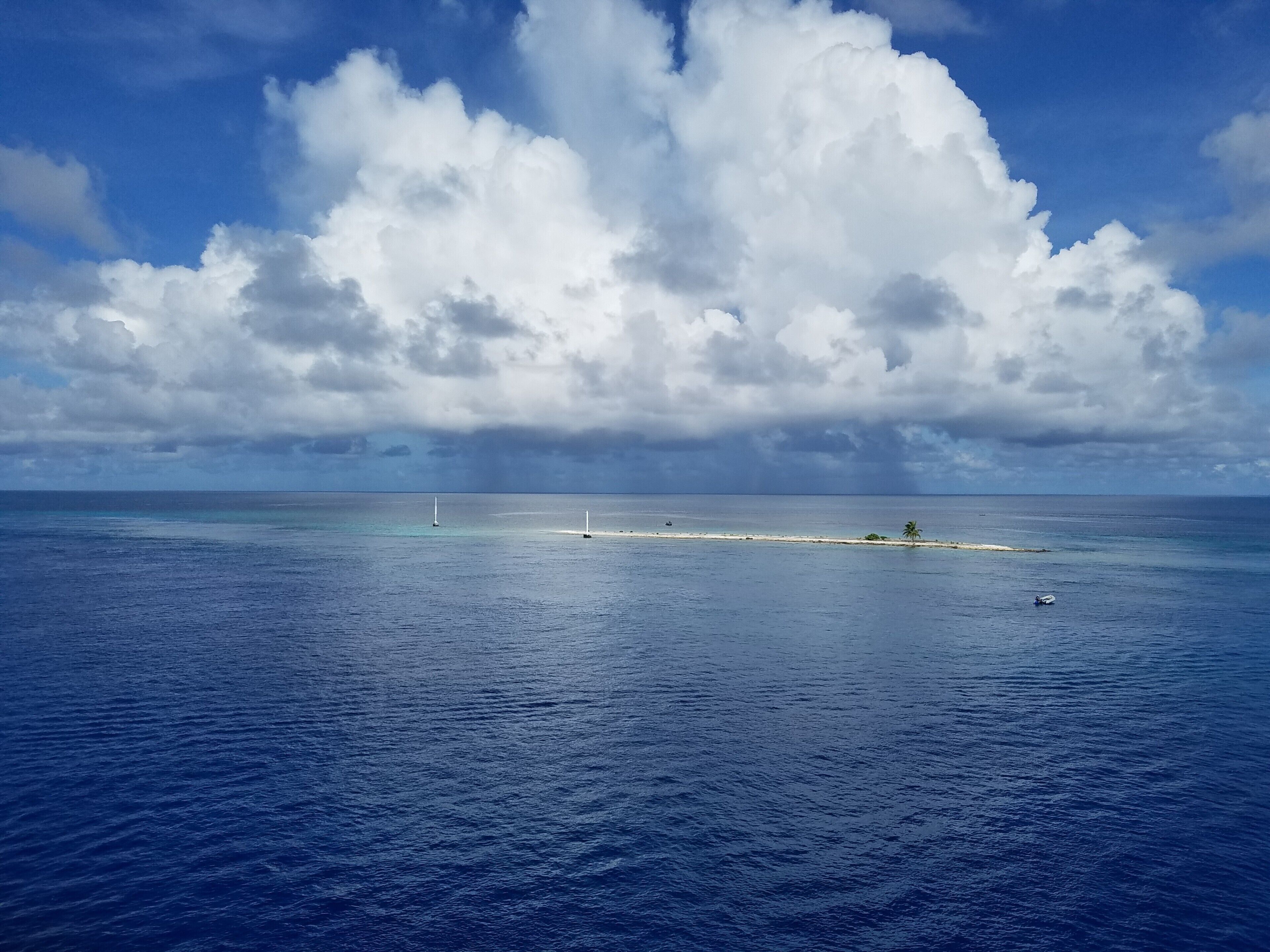 The reef off this small sandbar "island" in the middle of the huge lagoon of the Rangiroa Atoll is a great place for scuba diving. And that's just what we did, off the marina on the aft of the cruise ship M/S Paul Gauguin. The clouds camp up and smited our ship with a torrential downpour that caused our captain to leave the Tuamotus early, after a surprise typoon-like storm hit the ship the day before in Fakarava.  #blue #SouthPacific #adventure