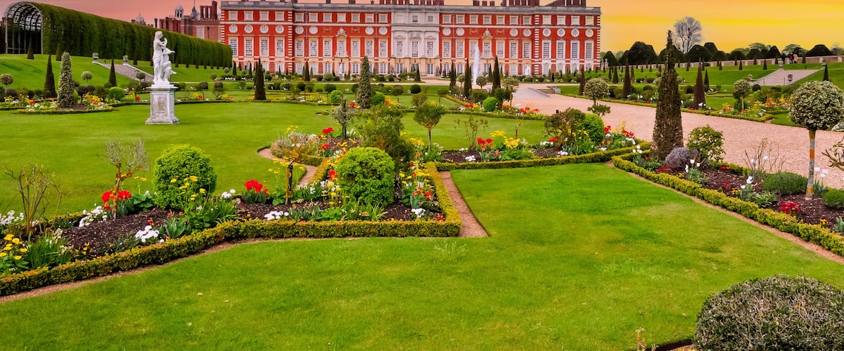 Hampton Court palace and gardens at sunset, London, UK