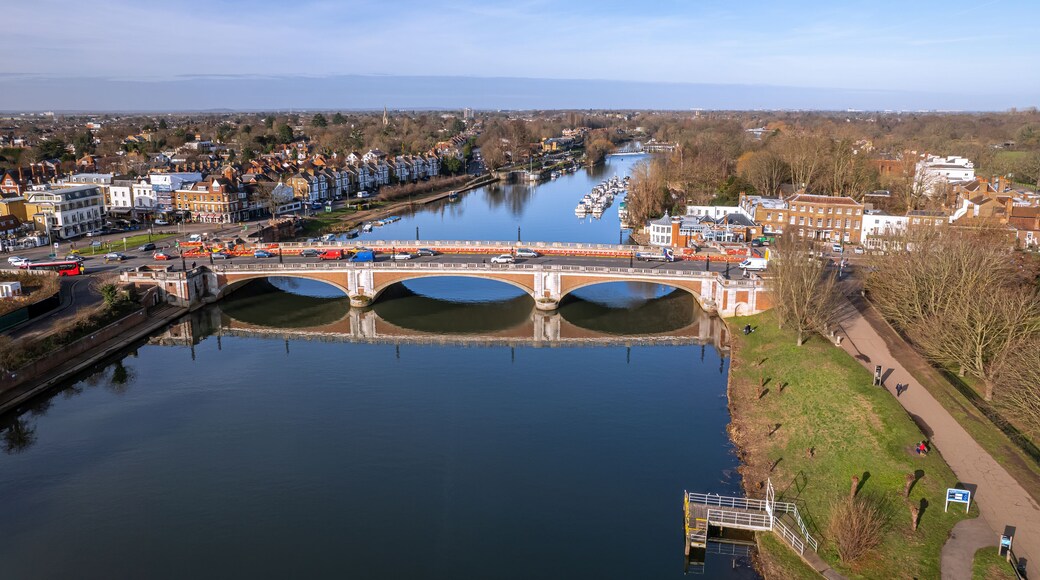 The drone aerial view of Hampton Court bridge and Thames river. Hampton Court Bridge crosses the River Thames in England between Hampton, London and East Molesey, Surrey.