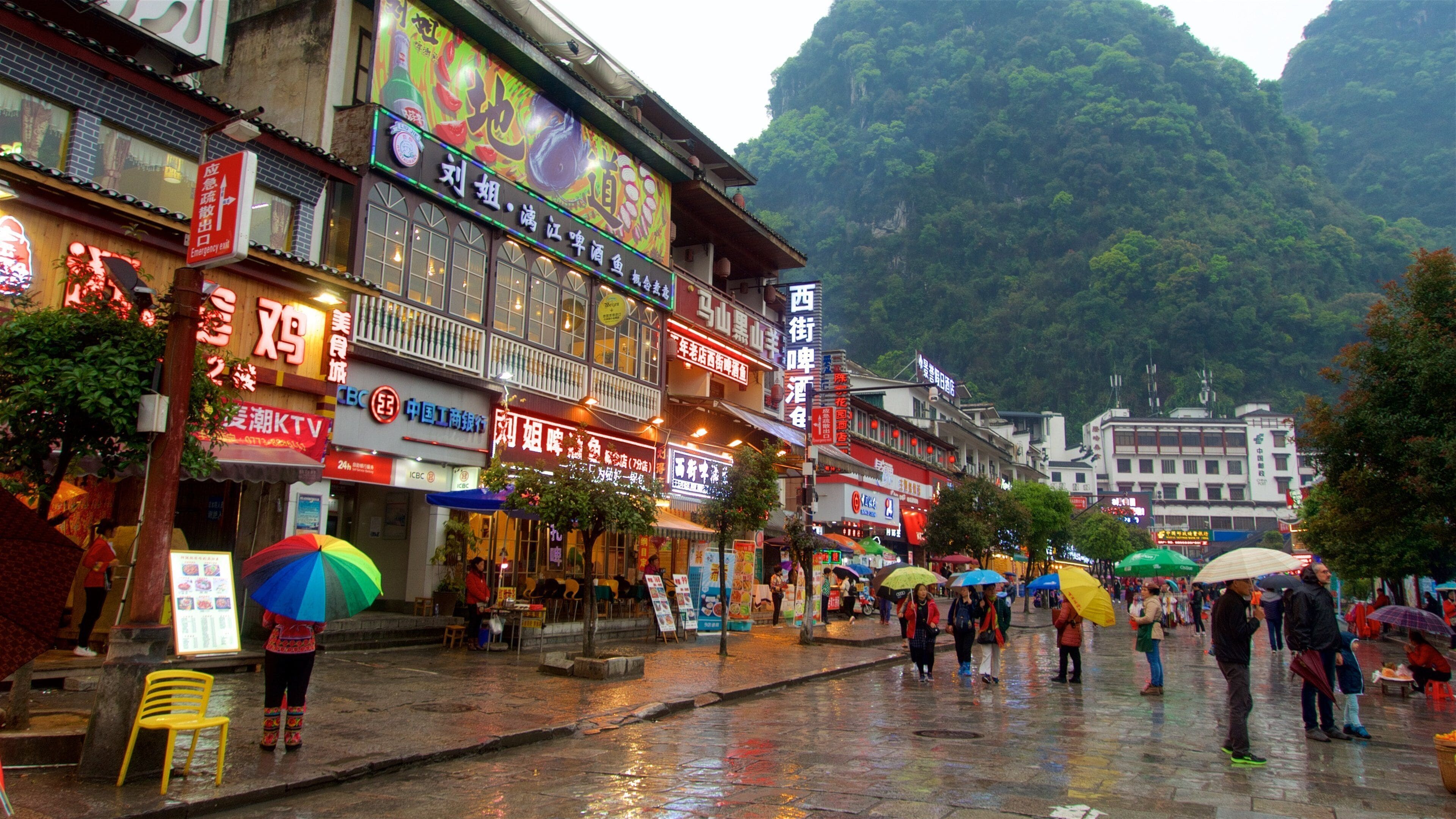 Yangshuo featuring signage as well as a small group of people