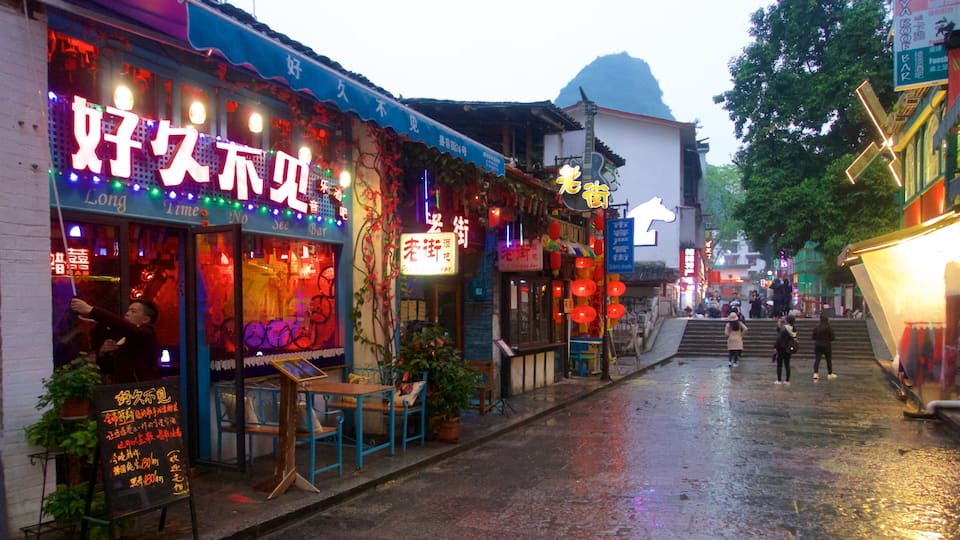 A street with shops and signs in a foreign language.
