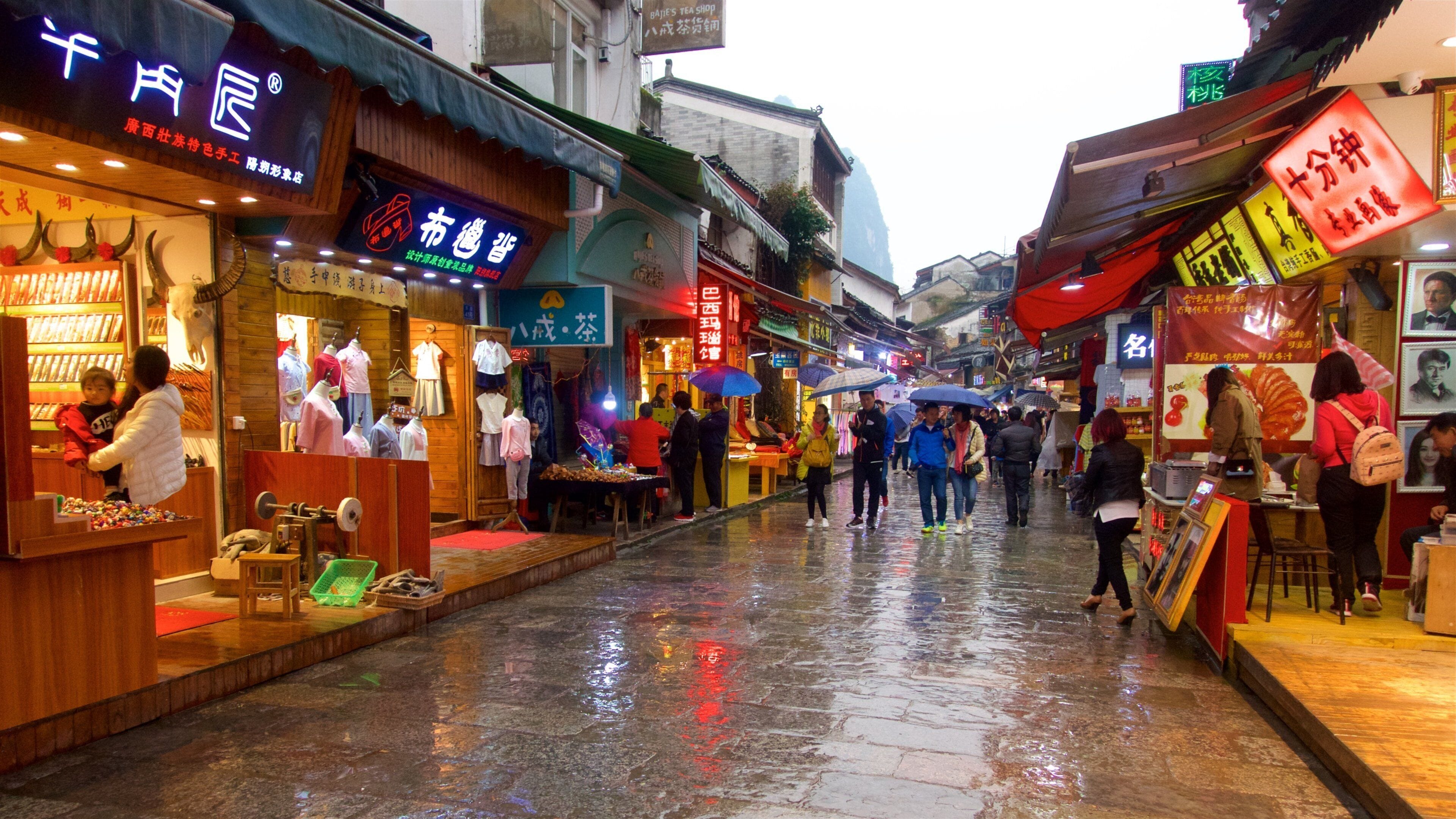 Yangshuo featuring markets as well as a small group of people