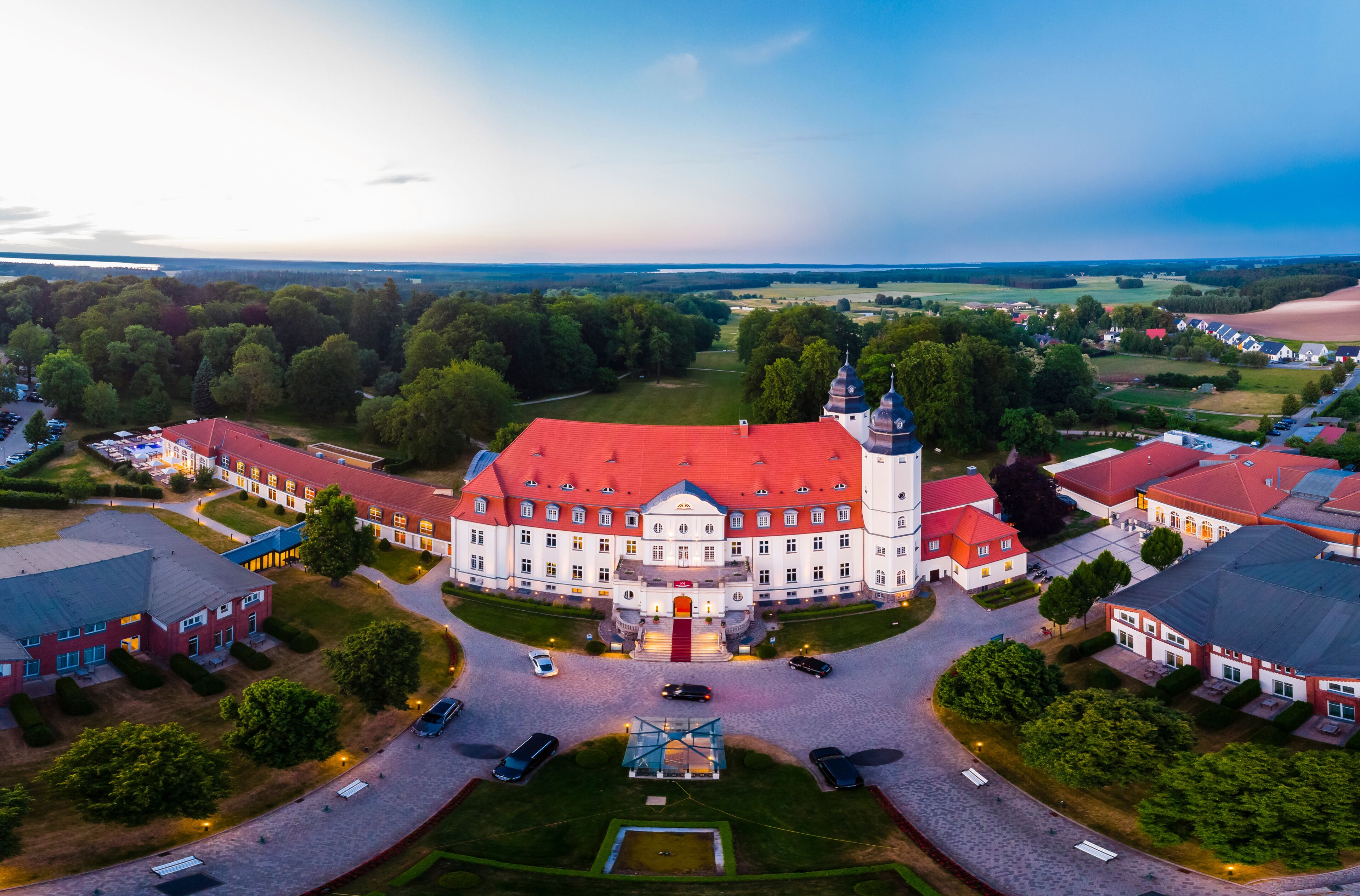 Germany, Mecklenburg-Western Pomerania, Mecklenburg Lake District, Goehren-Lebbin, Aerial view of Castle Hotel Fleesensee in the evening