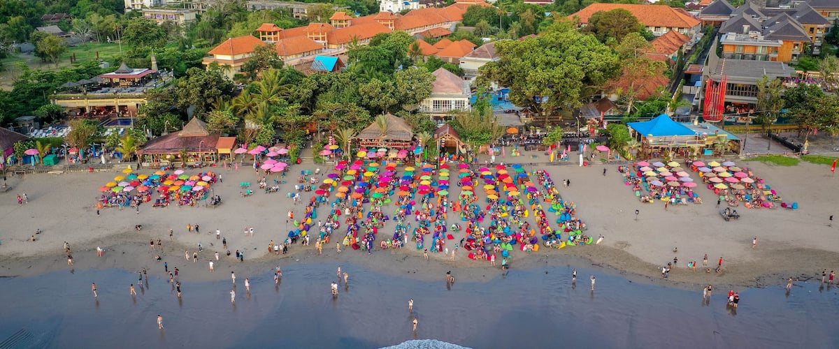 Beach with colorful umbrellas, aerial view, Seminyak, Bali, Indonesia; Shutterstock ID 1346342255; Purchase Order: SP-2032; Order Number: SP-2032 Hotels.com Go Guides; Client/Licensee: Hotels.com; Other: Lee Ban Twan