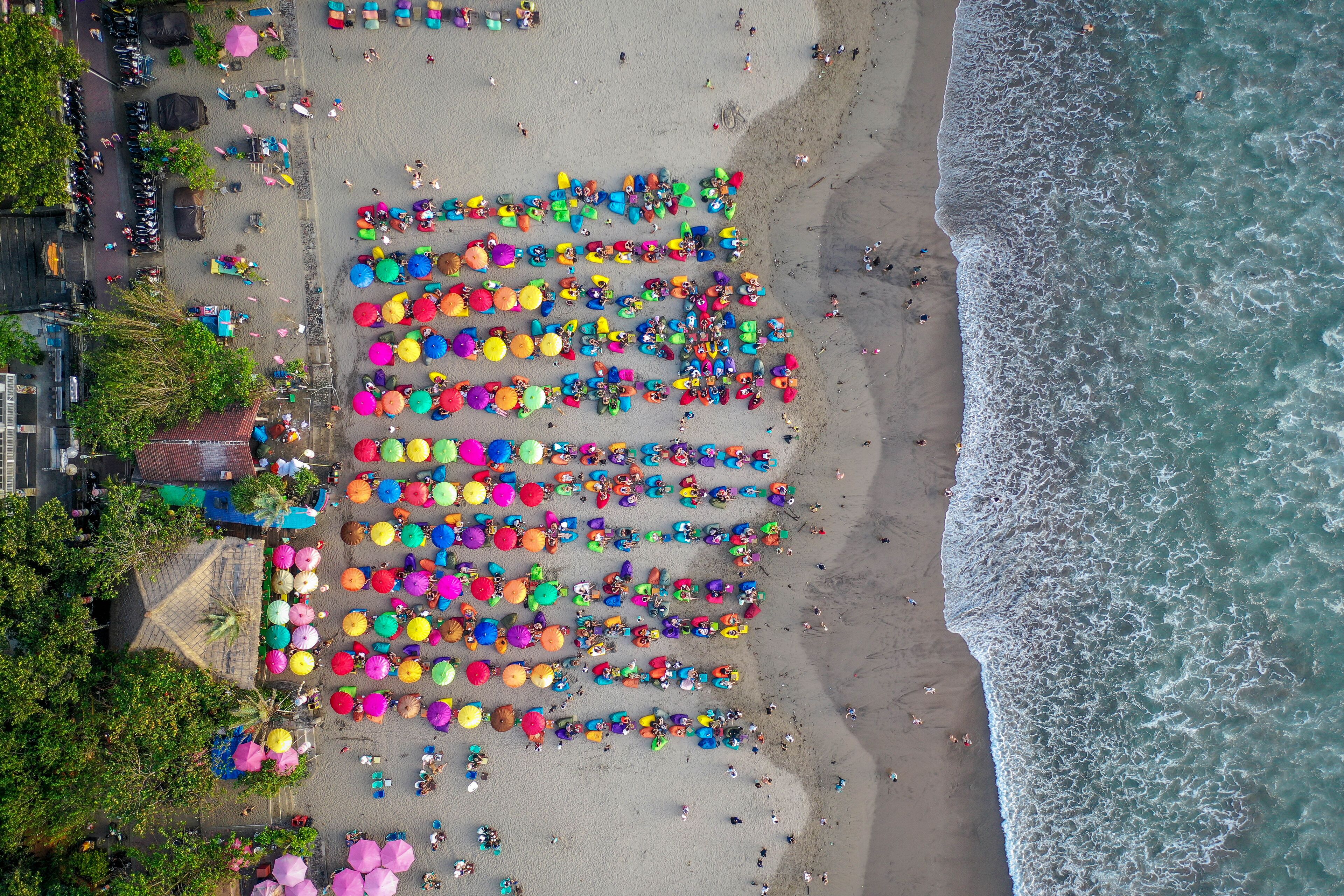Beach with colorful umbrellas, aerial view, Seminyak, Bali, Indonesia, Shutterstock ID 1346342261, Purchase Order: SP-2107, Order Number: SP-2107 Hotels.com Go Guides, Client/Licensee: Hotels.com, Oth
