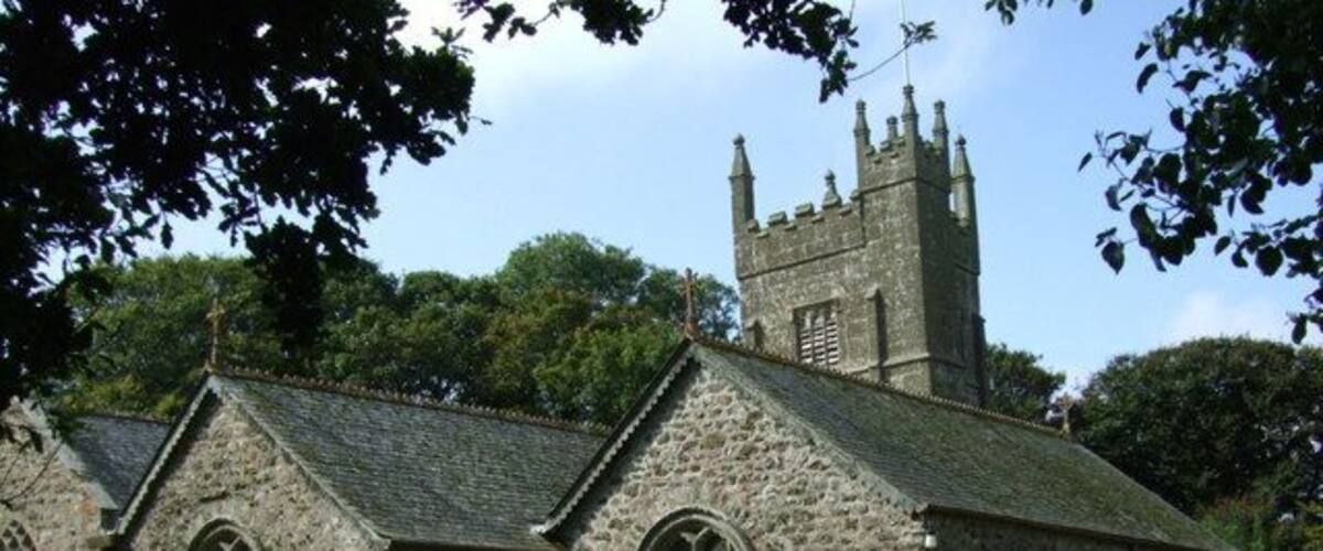 A stone church with a tower and arched windows.