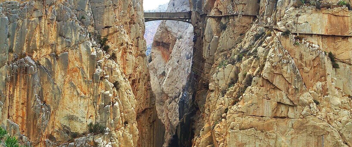 "The King's Little Pathway" spans the El Chorro gorge at a height of 100m. It was built in the early 1900s as an access path between nearby hydroelectric plants. The bridge got it's name in 1921 when King Alfonso XIII crossed it to help inaugurate a new dam.
The path rises to the bridge from either side of the gorge, snaking dramatically along the sheer cliff face. In recent years the path has been closed to all but rock-climbers, as many portions of the pathway had crumbled away.
However, the Spanish government recently completed a three-year restoration of the pathway, including guardrails, and it just opened yesterday - March 28, 2015! The 6€ entrance fee will be waived for the first six months, but you'll need to make reservations in advance: http://bit.ly/1BzhH8Y. Also, bear in mind that the path is one-way, so check the return bus schedule, or book a return crossing as well!
Lonely Planet has ranked the new pathway as one of the hottest new travel experiences for 2015. And finally, here is a link to a cool video of the restoration process: http://bit.ly/1vCkulv