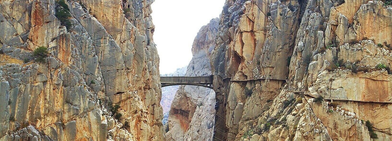 "The King's Little Pathway" spans the El Chorro gorge at a height of 100m. It was built in the early 1900s as an access path between nearby hydroelectric plants. The bridge got it's name in 1921 when King Alfonso XIII crossed it to help inaugurate a new dam.
The path rises to the bridge from either side of the gorge, snaking dramatically along the sheer cliff face. In recent years the path has been closed to all but rock-climbers, as many portions of the pathway had crumbled away.
However, the Spanish government recently completed a three-year restoration of the pathway, including guardrails, and it just opened yesterday - March 28, 2015! The 6€ entrance fee will be waived for the first six months, but you'll need to make reservations in advance: http://bit.ly/1BzhH8Y. Also, bear in mind that the path is one-way, so check the return bus schedule, or book a return crossing as well!
Lonely Planet has ranked the new pathway as one of the hottest new travel experiences for 2015. And finally, here is a link to a cool video of the restoration process: http://bit.ly/1vCkulv