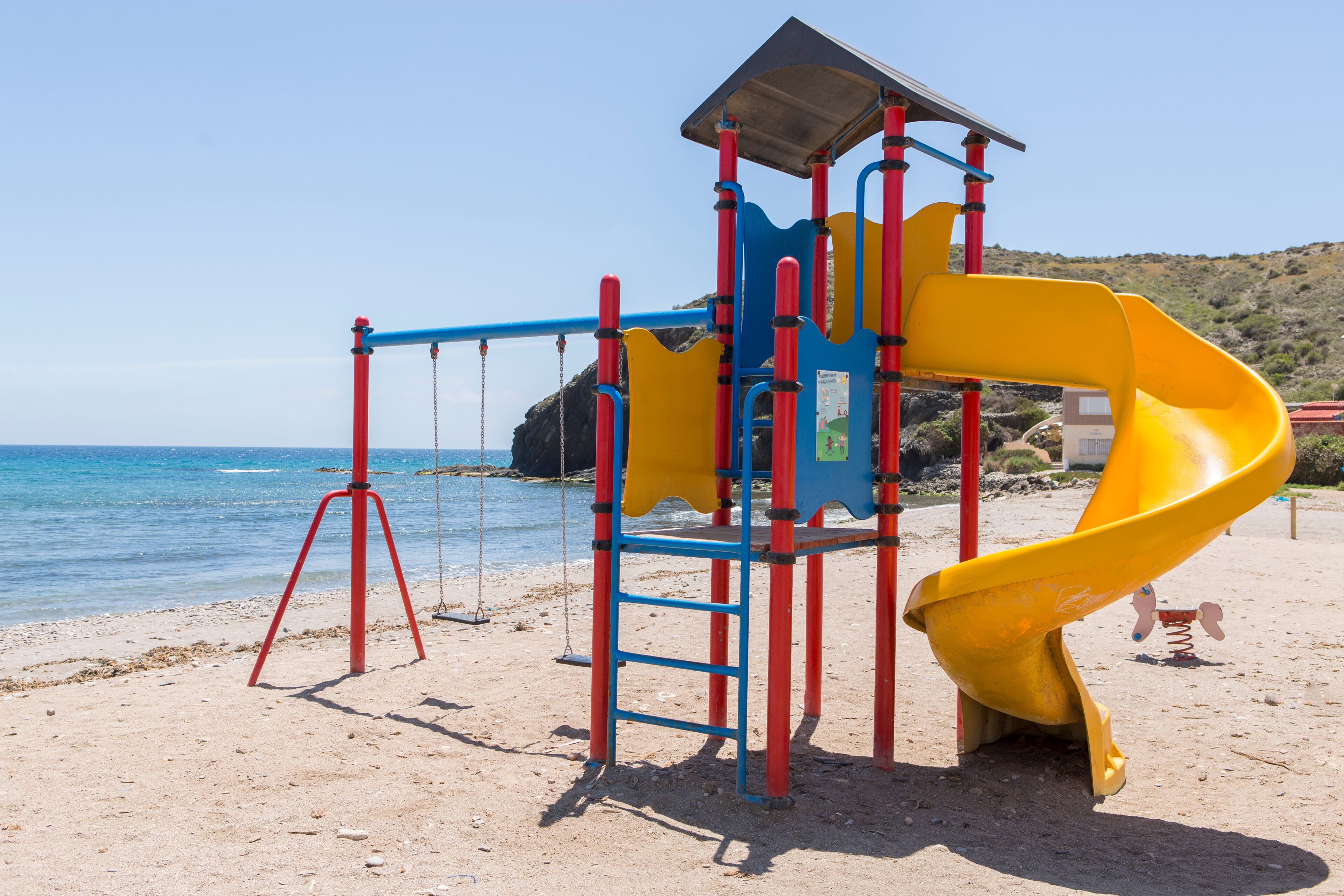 Children's playground with slide, swings and climbing area, located on the shore of the Spanish beach of Puntas de Calnegre.