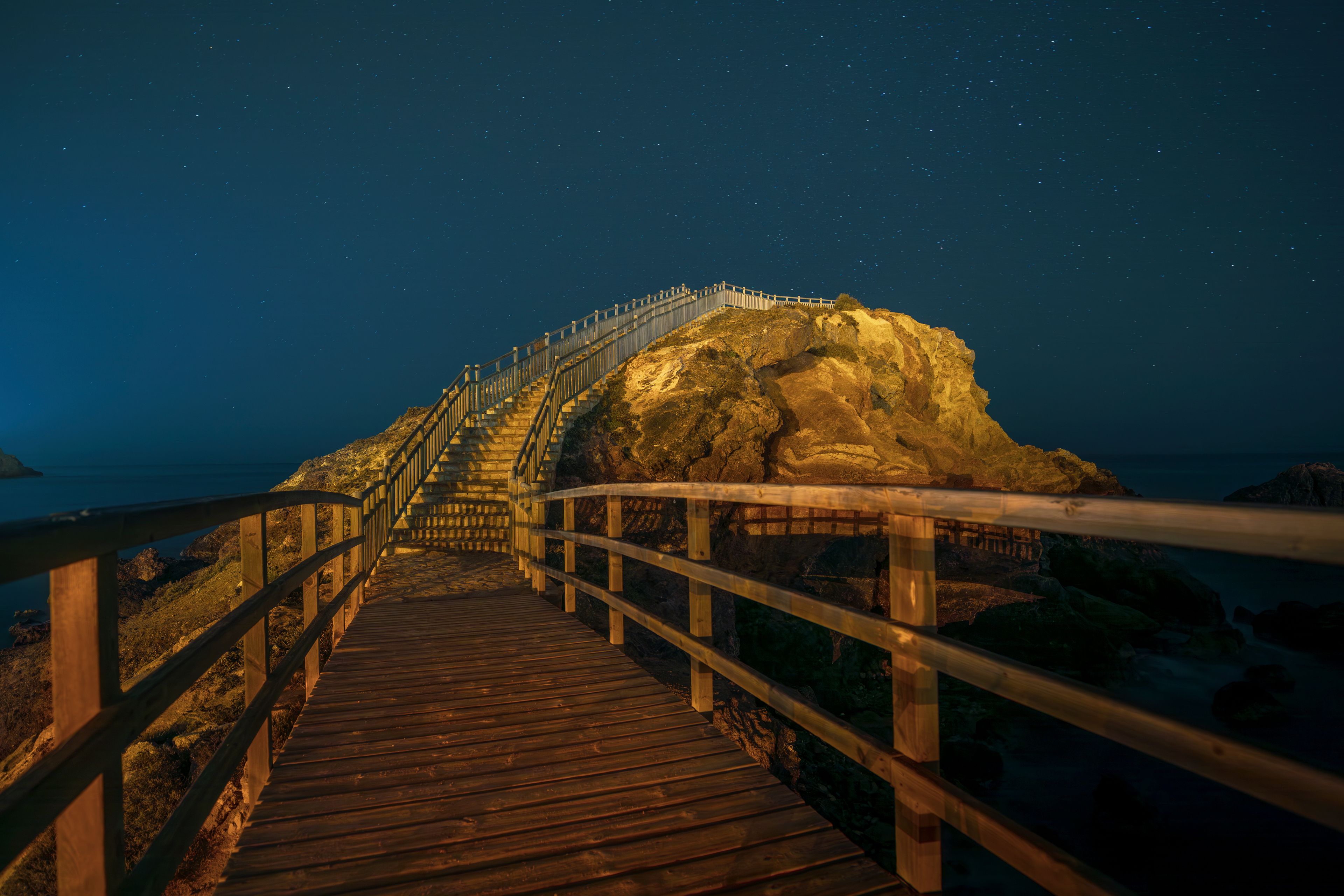 Mirador del Cabezo del Gavilán on the beaches of Puerto de Mazarrón, Region of Murcia, Spain, at night, with artificial lighting and starry sky