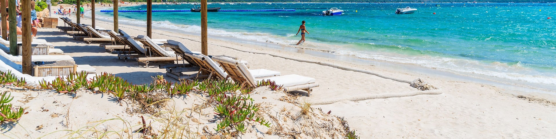 Sun umbrellas on beautiful beach in Saint Cyprien coastal town, Corsica island, France; Shutterstock ID 300476354; Purchase Order: SP-1394 HA Batch 3 Part 1; Order Number: ; Client/Licensee: HomeAway;