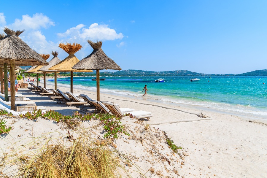 Sun umbrellas on beautiful beach in Saint Cyprien coastal town, Corsica island, France; Shutterstock ID 300476354; Purchase Order: SP-1394 HA Batch 3 Part 1; Order Number: ; Client/Licensee: HomeAway;