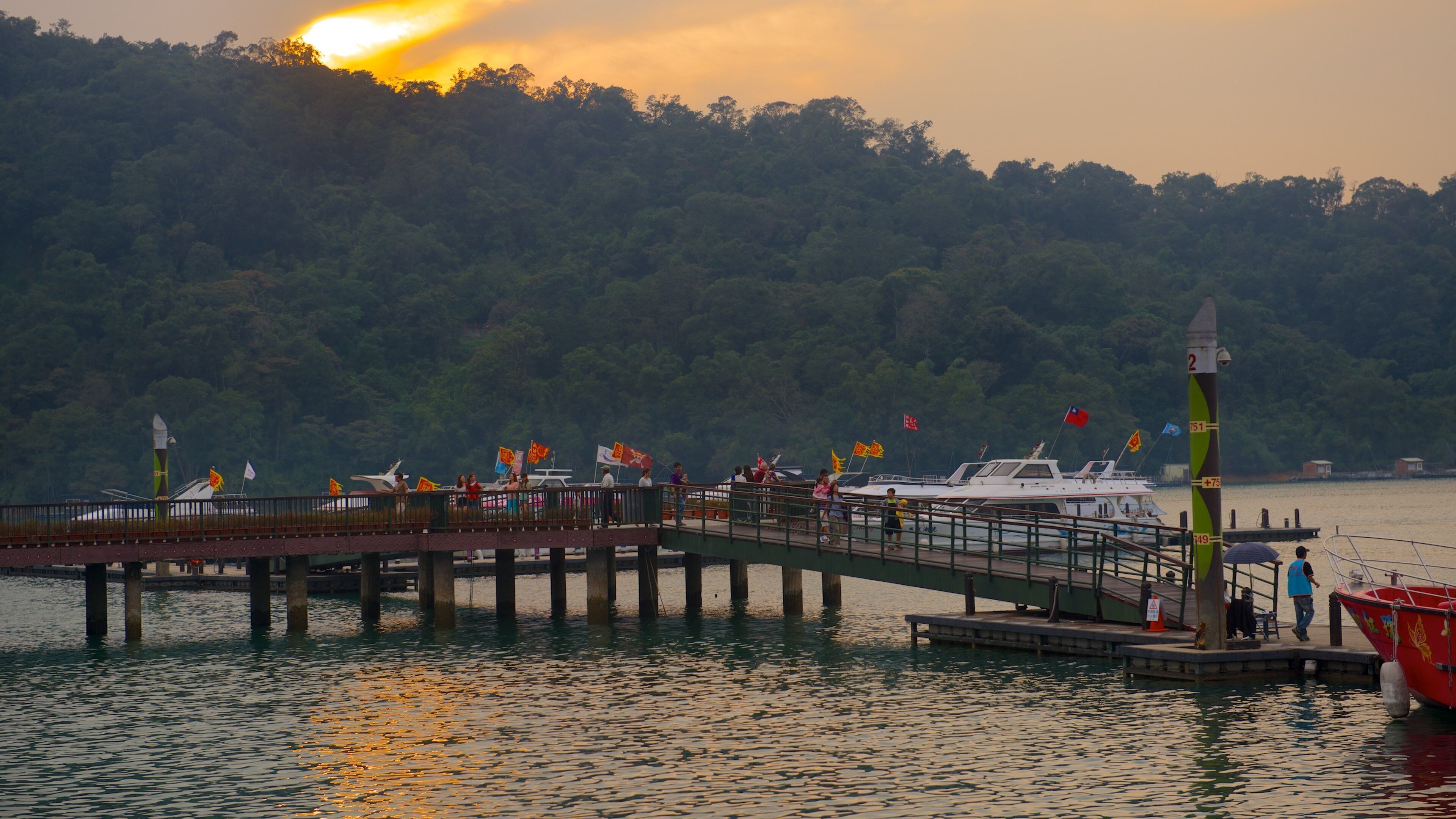 Sun Moon Lake featuring a bay or harbor, a sunset and a lake or waterhole
