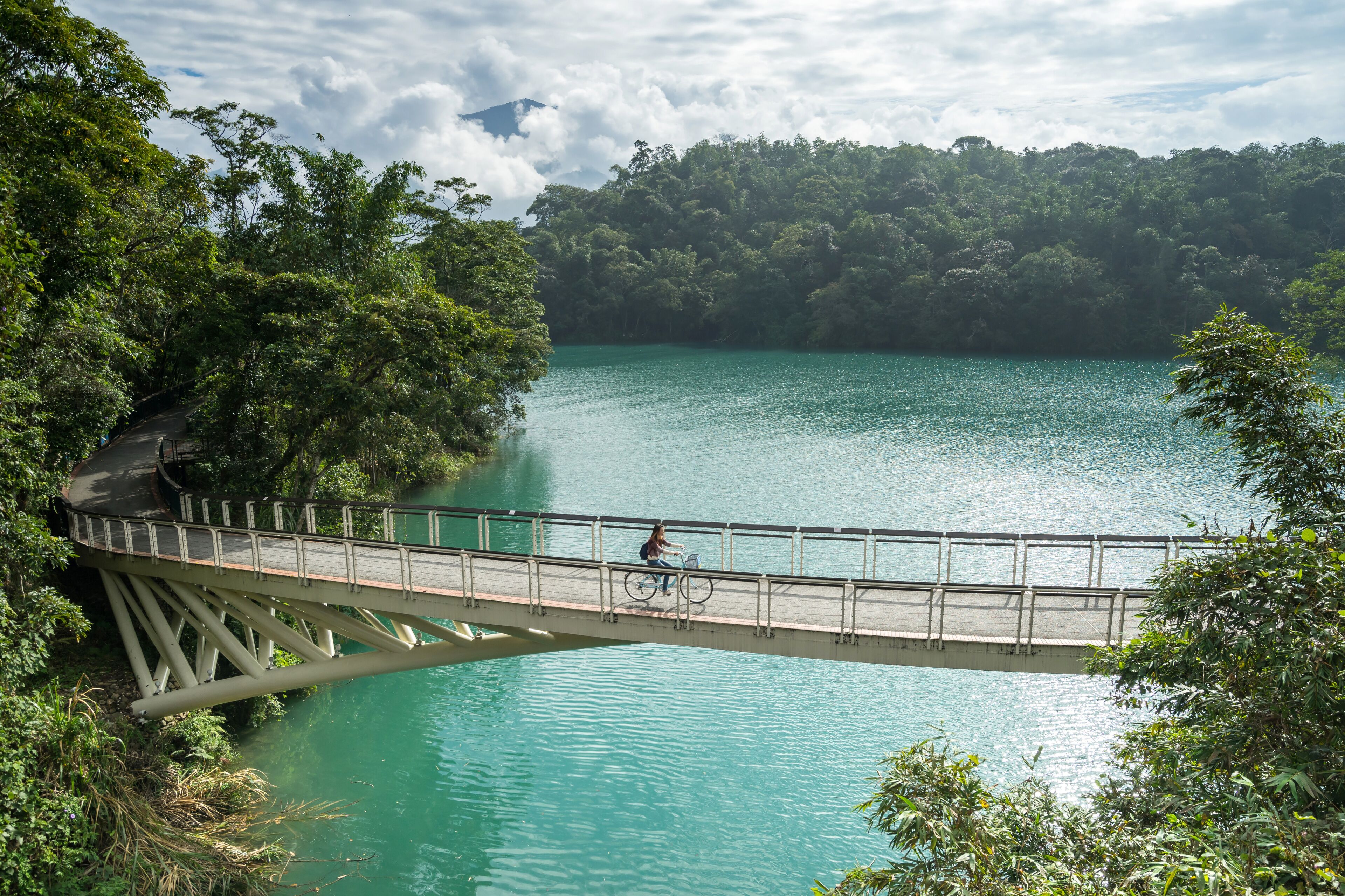 Young woman riding bicycle on Sun Moon lake bike trail