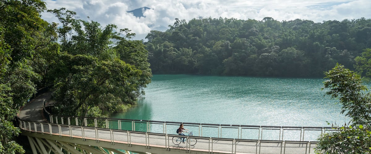 Young woman riding bicycle on Sun Moon lake bike trail