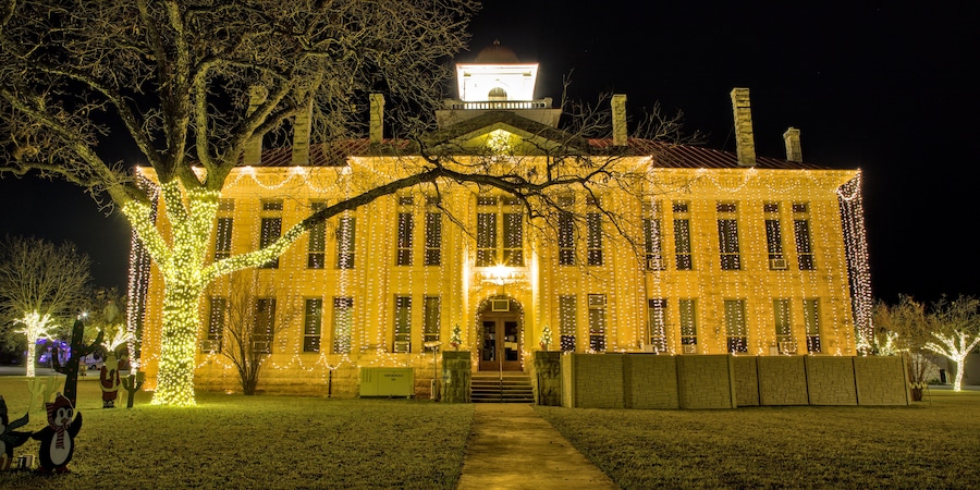 The Blanco County Court House is all decked out for the Christmas holiday season with strings of lights hanging from top to bottom on all for sides of the building. Johnson City, Texas.