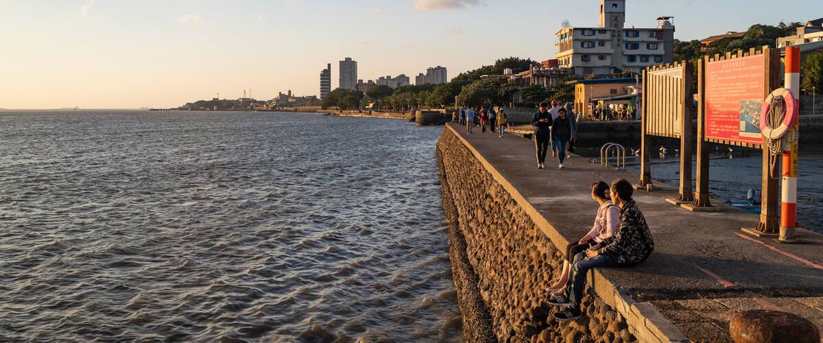Tamsui showing a sunset, a coastal town and general coastal views