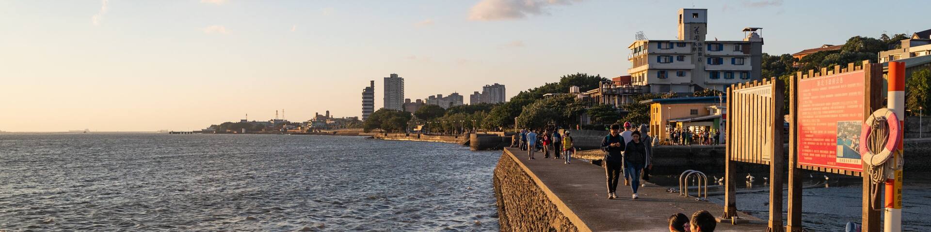Tamsui showing a sunset, a coastal town and general coastal views