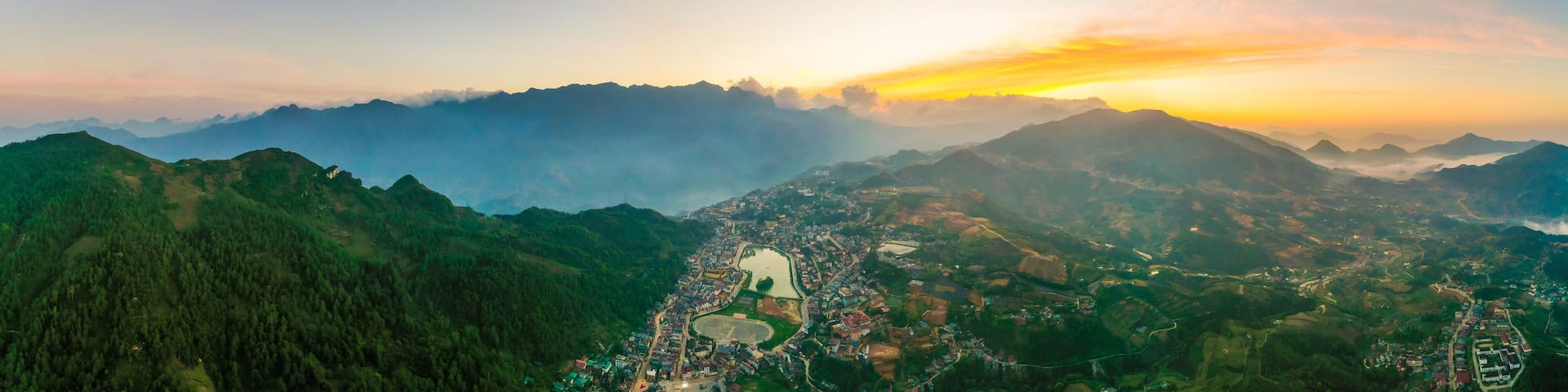 Aerial view of panorama landscape at the hill town in Sapa city, Vietnam with the sunny light and sunset, mountain view in the clouds