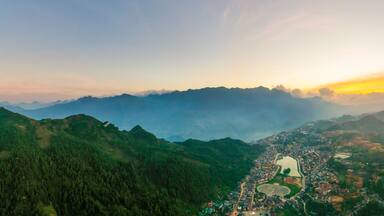 Aerial view of panorama landscape at the hill town in Sapa city, Vietnam with the sunny light and sunset, mountain view in the clouds