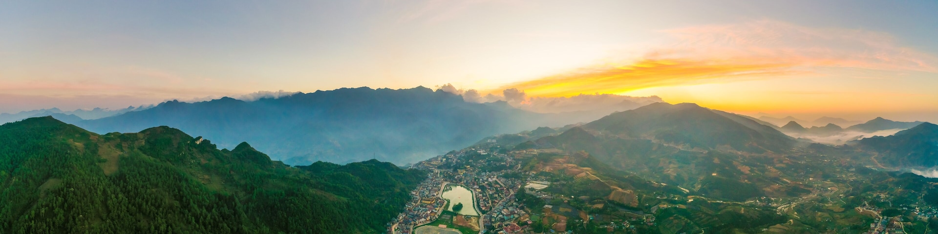 Aerial view of panorama landscape at the hill town in Sapa city, Vietnam with the sunny light and sunset, mountain view in the clouds