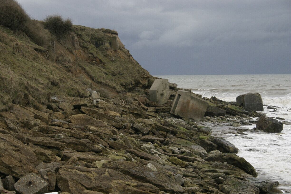 Down the wooden steps and this is the beach to the west.  Large rocks and concrete debris.