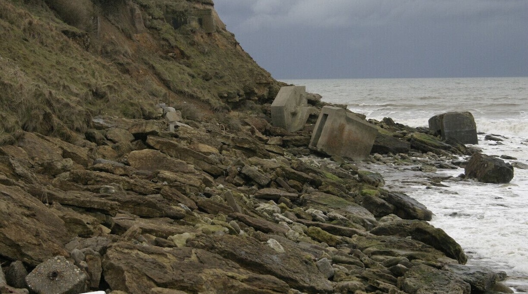 Down the wooden steps and this is the beach to the west. Large rocks and concrete debris.