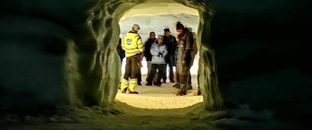 An ice cave with a group of people inside.