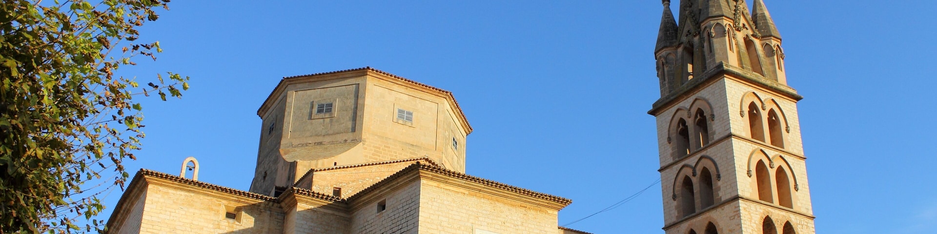 A church with a tall bell tower and a clock.