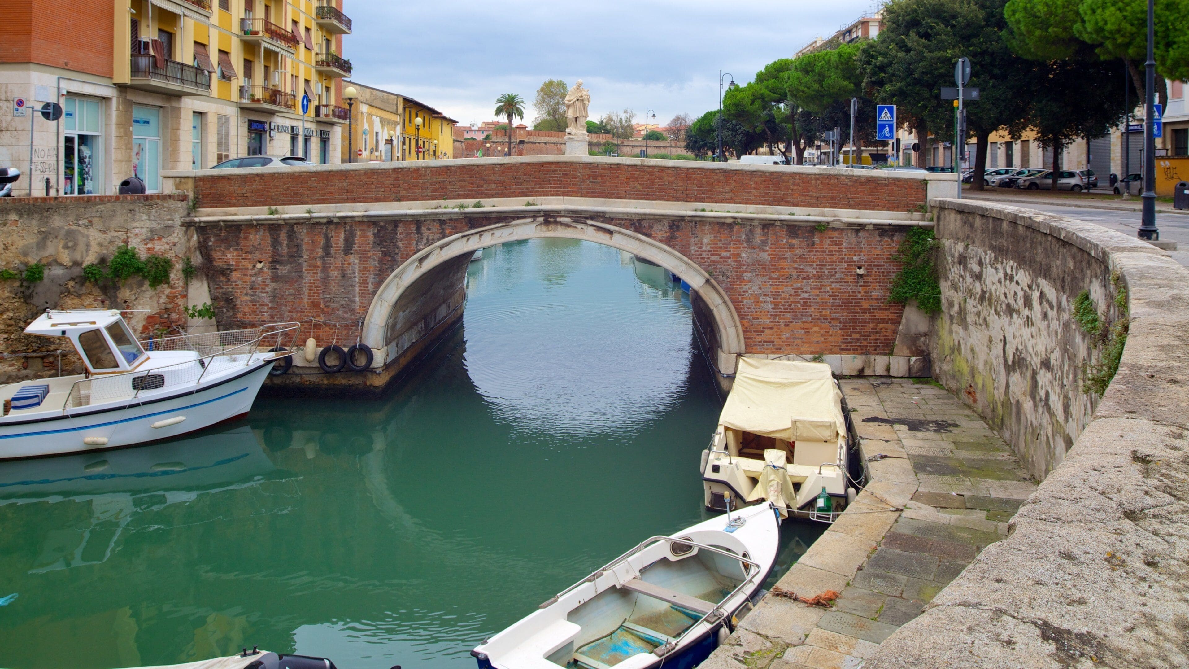 Livorno showing a bridge, a river or creek and street scenes