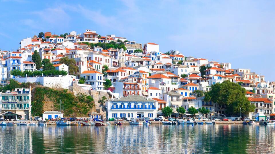 A coastal town with colorful buildings, a marina, and boats.