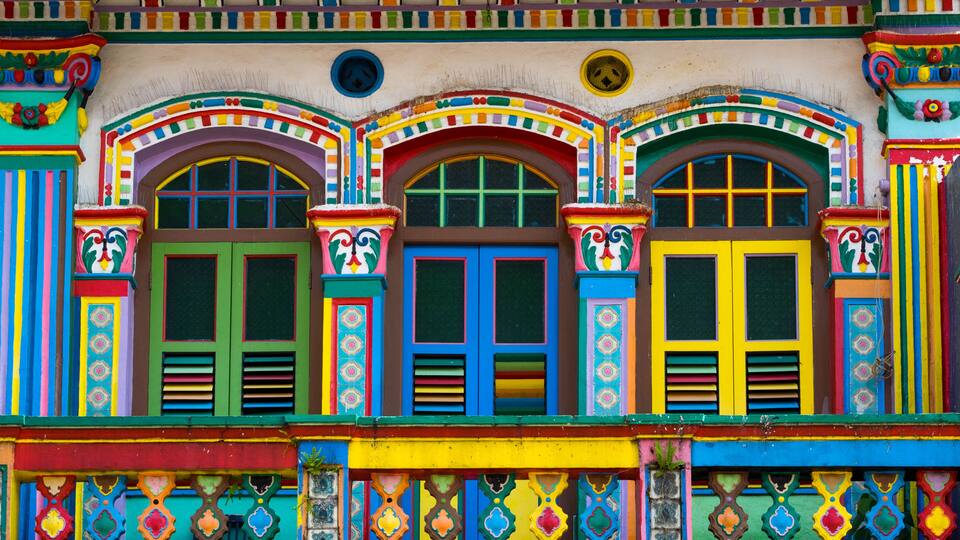 A colorful building with vibrant facades, ornate window frames, and decorative patterns.