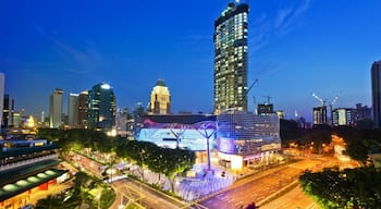 Singapore showing night scenes, a high-rise building and city views