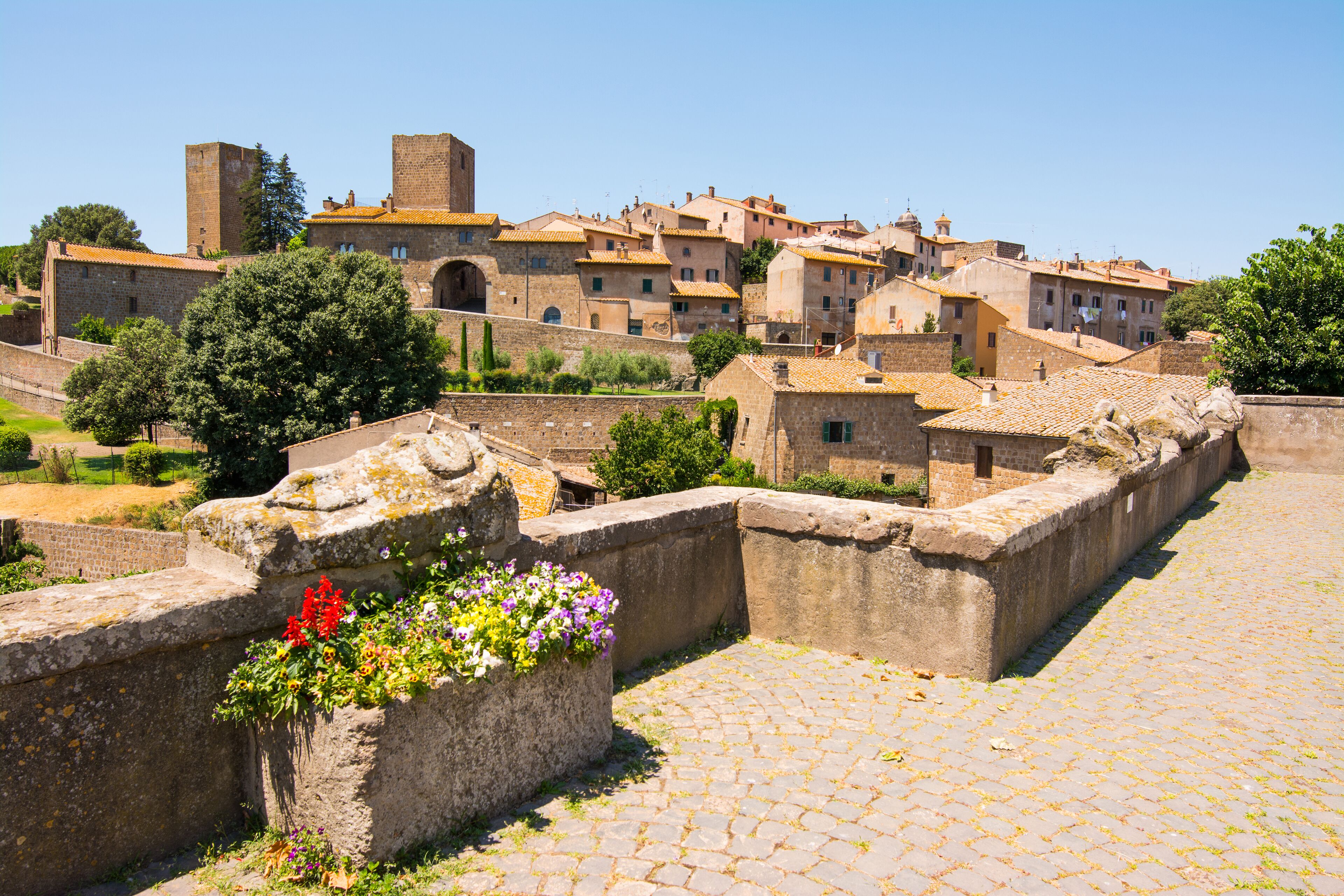A historic town with stone walls, cobblestone streets, and traditional buildings.