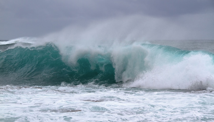 A large wave crashing onto the shore.