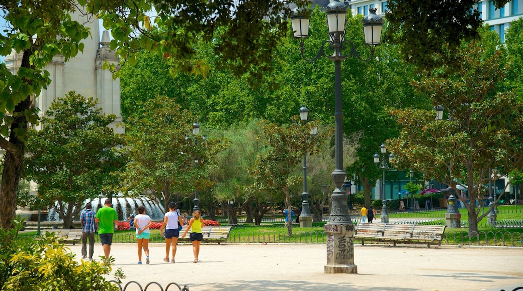 Plaza de Espana showing a square or plaza and a garden as well as a small group of people