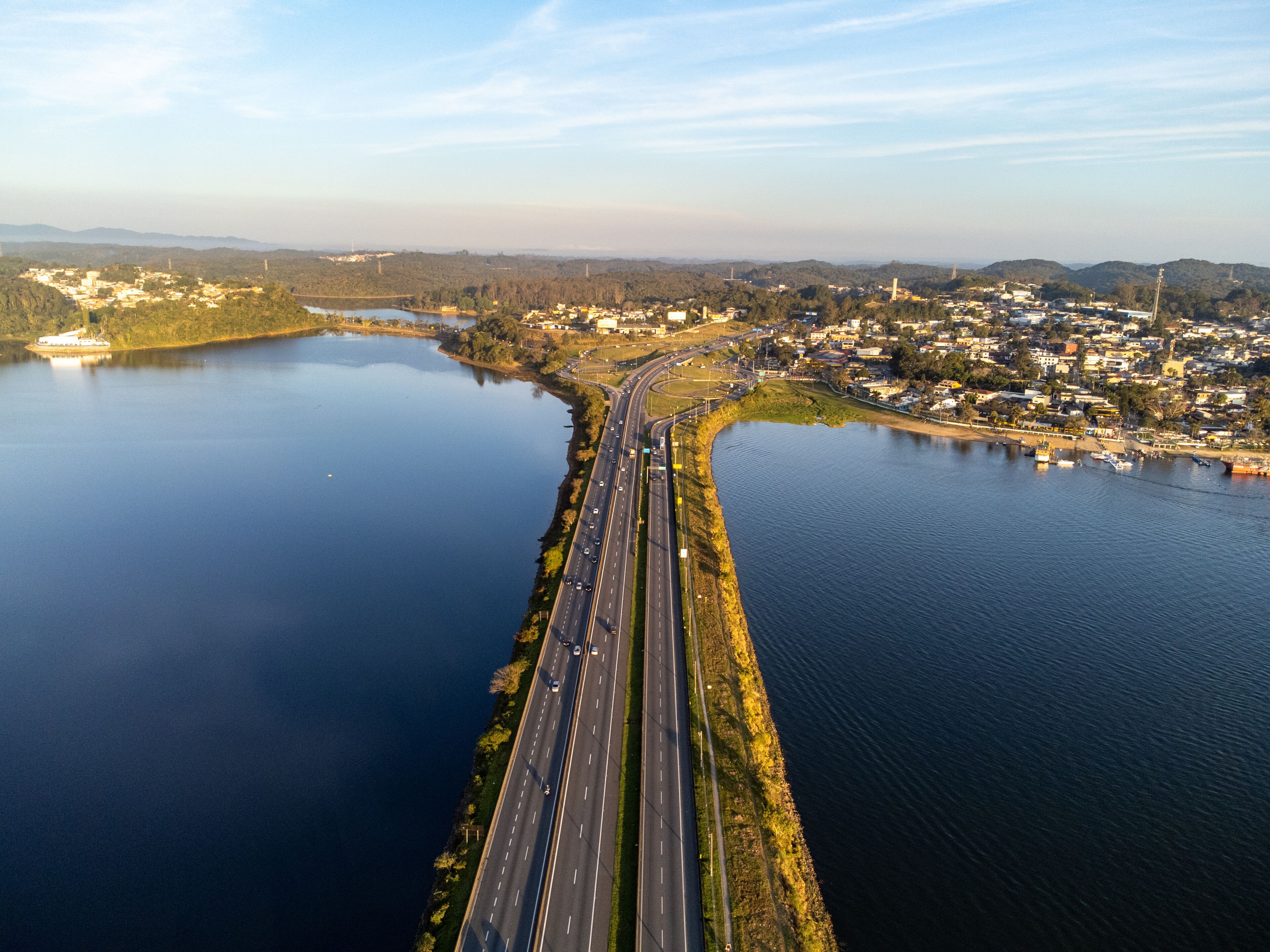 Aerial view of Anchieta Highway bridge crossing Billings Reservoir at sunset in Sao Bernardo do Campo, Brazil