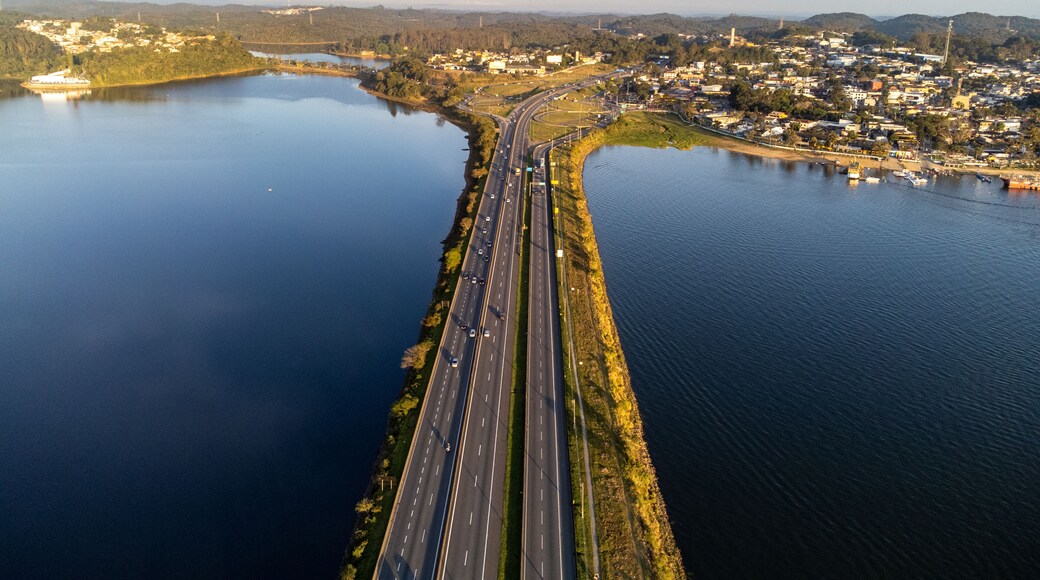 Aerial view of Anchieta Highway bridge crossing Billings Reservoir at sunset in Sao Bernardo do Campo, Brazil