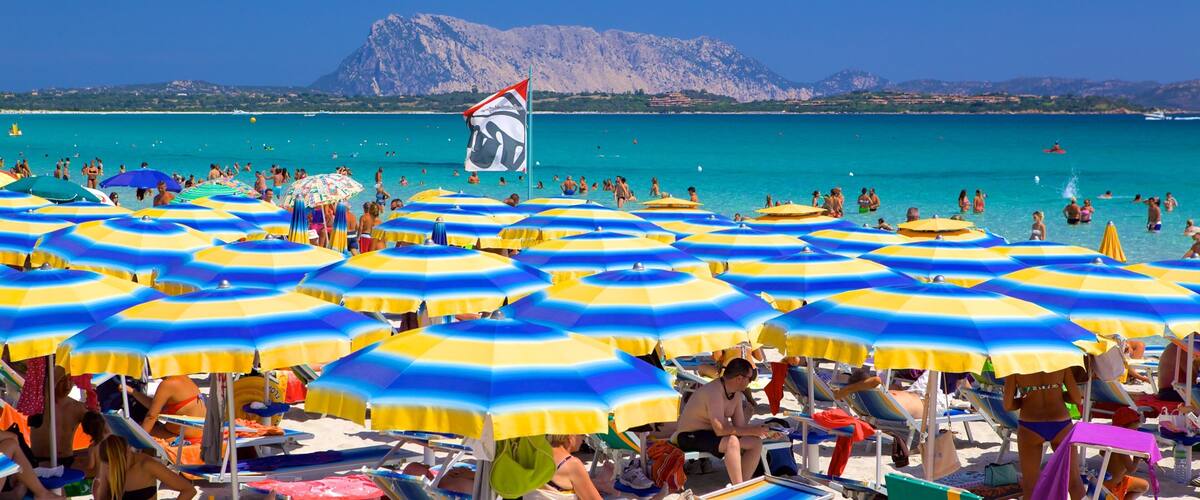 San Teodoro showing a beach and general coastal views as well as a large group of people