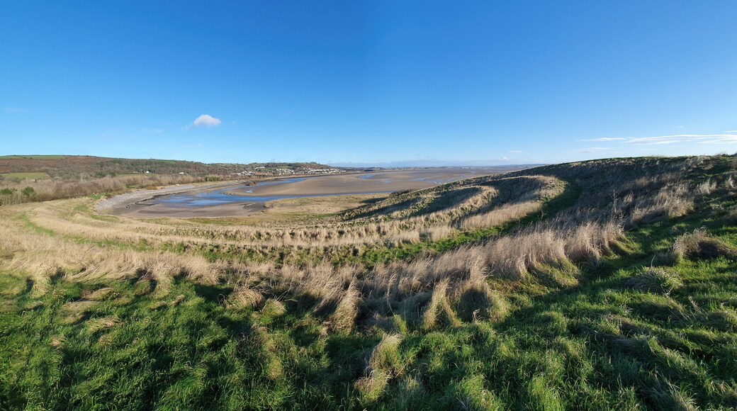 Panoramic coastline view of Teletubby Hill at Burry Port Carmarthenshire South Wales which is a popular tourist holiday travel destination and attraction landmark, stock photo image