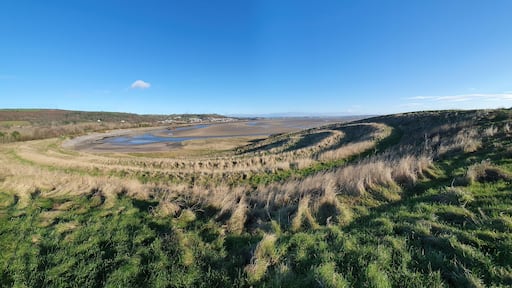 Panoramic coastline view of Teletubby Hill at Burry Port Carmarthenshire South Wales which is a popular tourist holiday travel destination and attraction landmark, stock photo image