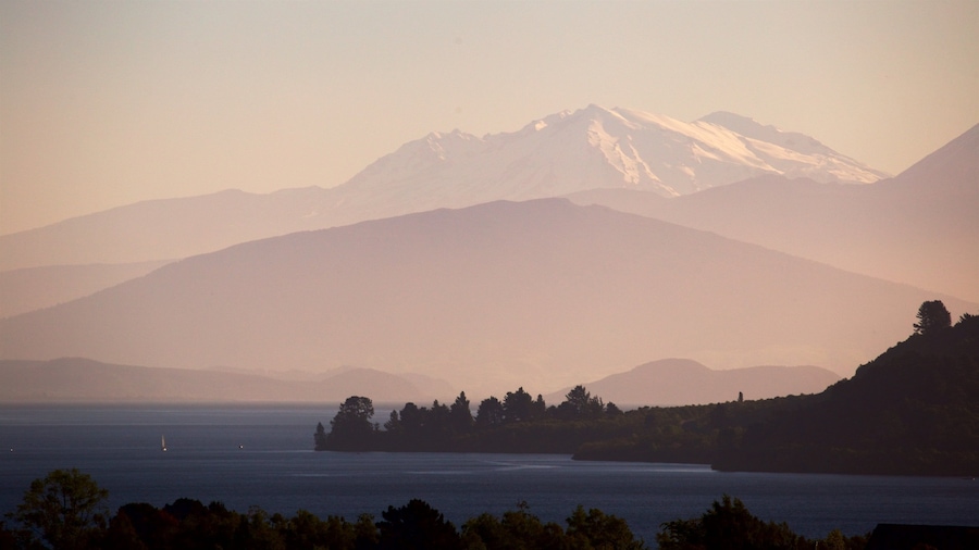 Lake Taupo showing a sunset, a lake or waterhole and mountains